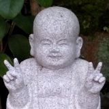 Statue of smiling Buddhist monk.